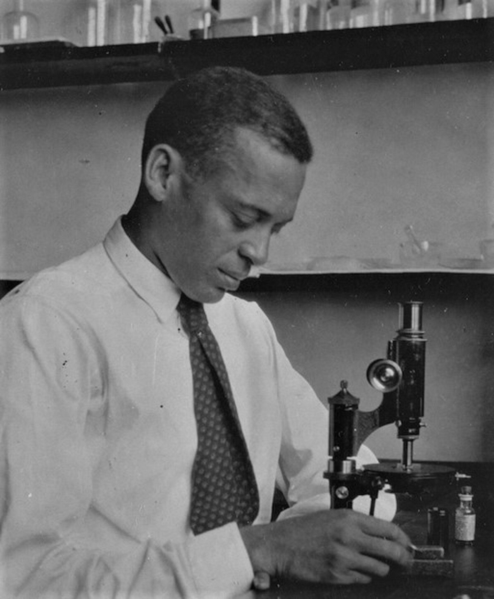 A man looking at a microscope